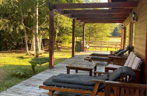 Pucon House | A cozy home built with local woods, featuring a private beach on the Liucura River.