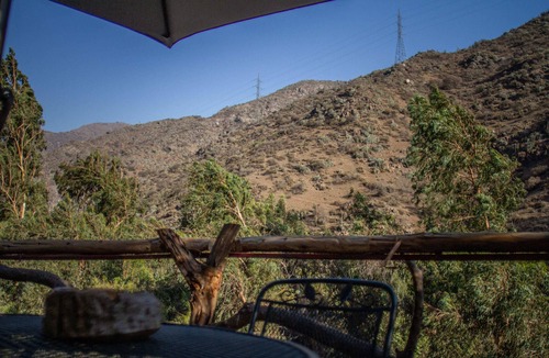 Lo Barnechea House | Ñilhue house with forest and river