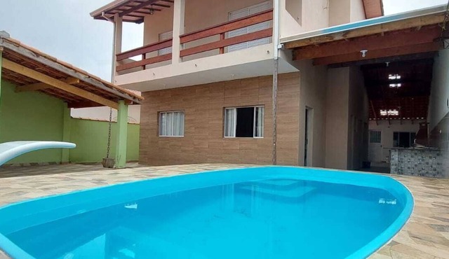 Two-story house with pool in gated community. in CARAGUATATUBA